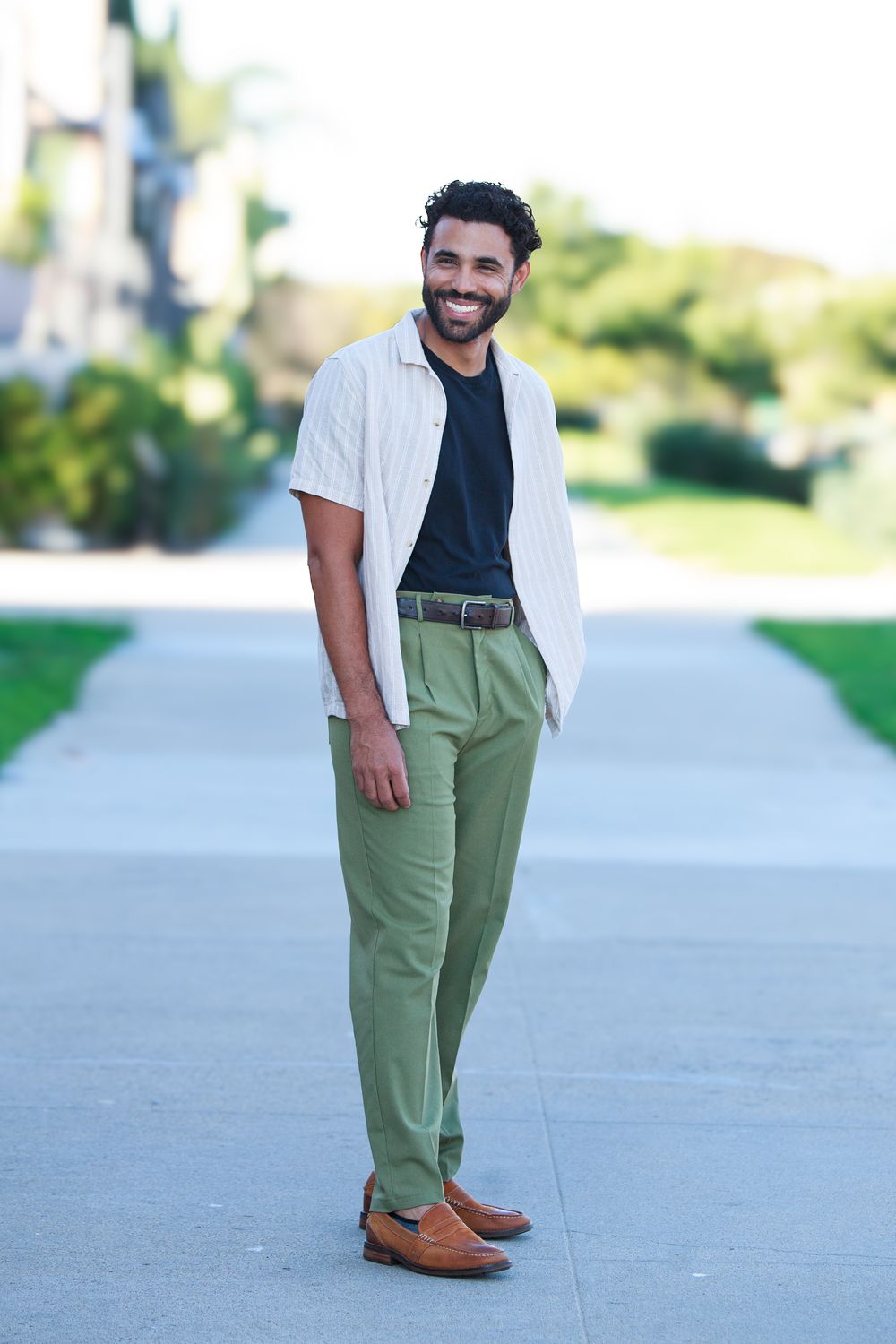Full-length photo in a linen shirt and green trousers