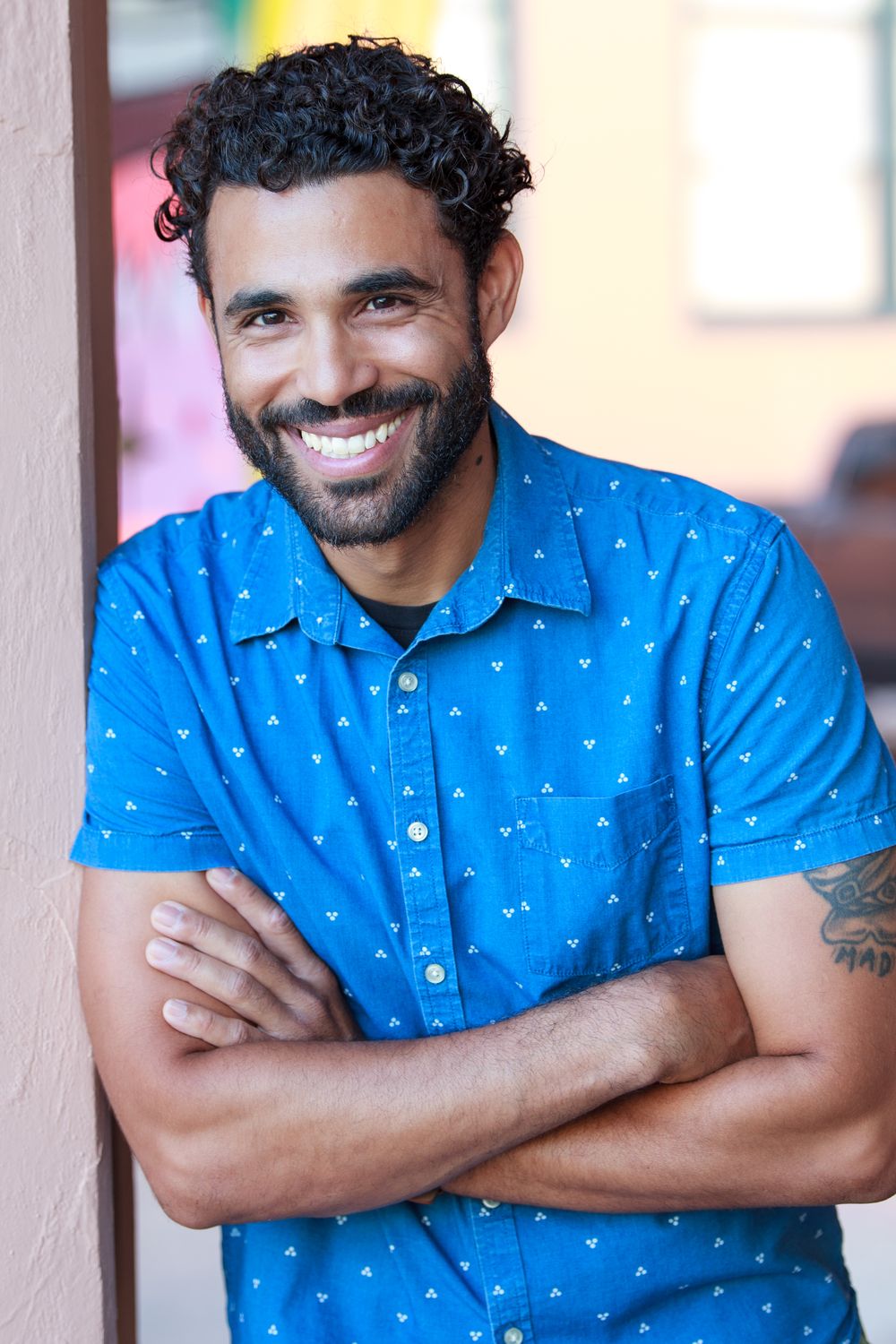Smiling headshot in a blue patterned shirt
