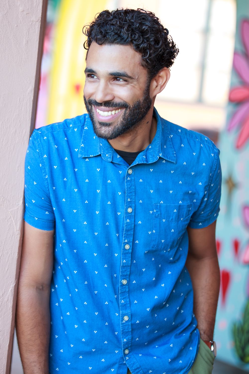 Laughing, looking off camera, in a blue shirt